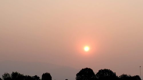 Sunrise over the Sandia Mountains on Aug. 9, 2021, shows heavy smoke from forest fires in the West. Photo by Kent Salazar.